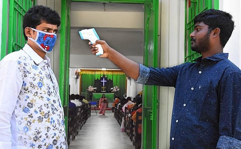 A man gets his temperature checked before attending Sunday mass at a church in Tirupati. (Photo | Madhav K, EPS)