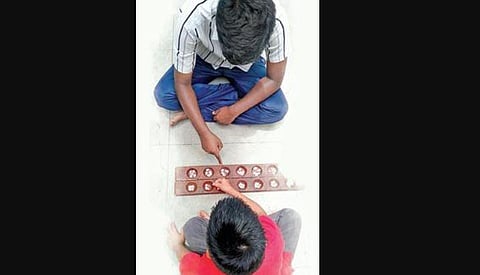 Channa Mane or Aliguli Mane—a board with hollows and played with tamarind  seeds