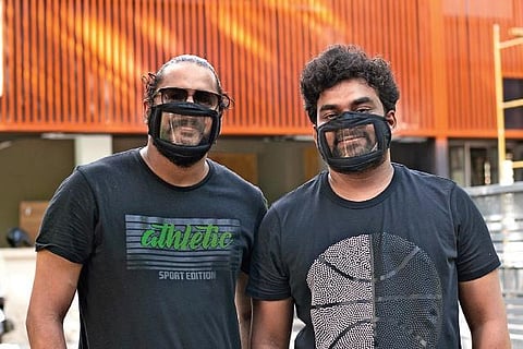 Jithin Lal (left) and Alameen Raja wearing the ‘Smile Mask’