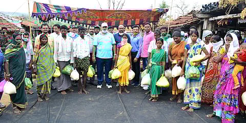 Nirmal SP C Shashidhar Raju distributes rice and other essentials to 50 Kolamguda tribal families in the district. (Photo| EPS)