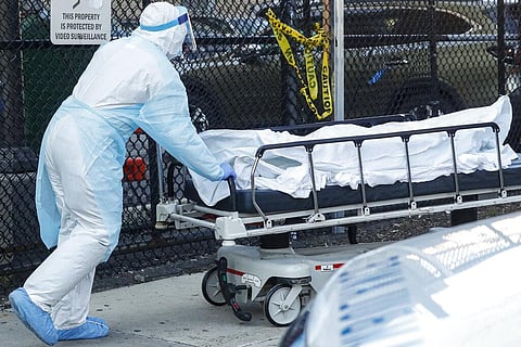 Image of a medical worker wearing personal protective equipment wheeling a dead body used for representational purpose only (Photo | AP)