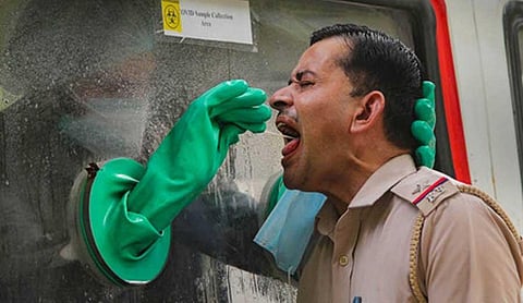 A medic collects samples for COVID-19 swab test from a policeman, during the ongoing COVID-19 nationwide lockdown, in Gurugram, Monday, June 15, 2020. (Photo | PTI)