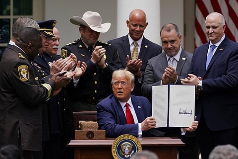 Law enforcement officials applaud after President Donald Trump signed an executive order on police reform, in the Rose Garden of the White House, Tuesday, June 16, 2020, in Washington. (Photo | AP)
