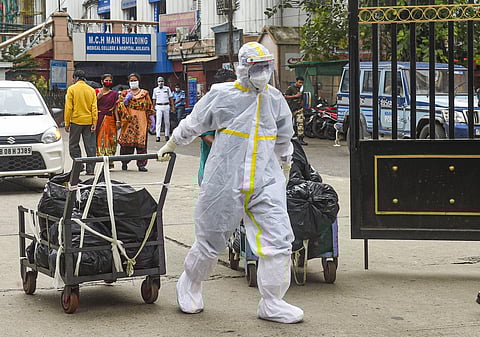 A health worker carries medical waste for disposal at Calcutta Medical College Hospital during the ongoing nationwide COVID-19 lockdown in Kolkata Tuesday June 16 2020. (Photo | PTI)