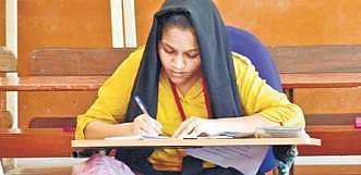 Image of a student writing second PUC exams used for representational purpose. 