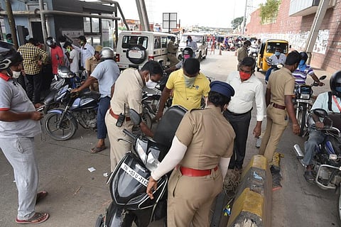 Police checking the vehicles at Sholavaram toll gate. (Photo | R Satish Babu, EPS)