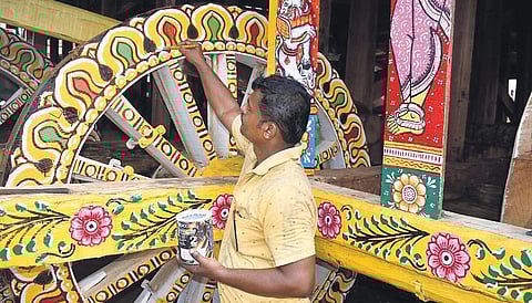 An artisan painting the wheel of a newly-constructed chariot in Puri. (File photo| EPS)