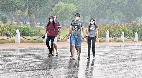 People enjoy a spell of sudden rain at Rajpath in New Delhi. (File Photo | Parveen Negi, EPS)