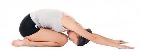 Balasana, or child's pose in Yoga.
