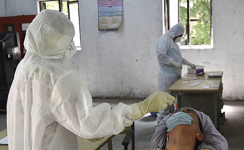 Health technicians use Rapid Antigen Kit to conduct COVID-19 testing, at a school in New Delhi. (Photo | PTI)