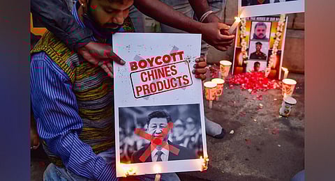 Citizens burn posters of Chinese President Xi Jinping after twenty Indian army personnel were martyred during a clash with Chinese troops in Ladakh's Galwan valley, during the ongoing COVID-19 nationwide lockdown, in Bengaluru. (Photo | PTI)