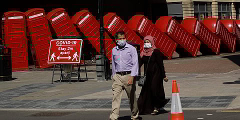 A sign requesting people stay two metres apart to try to reduce the spread of COVID-19 is displayed in front of 'Out of Order' box sculpture in London. (Photo| AP)