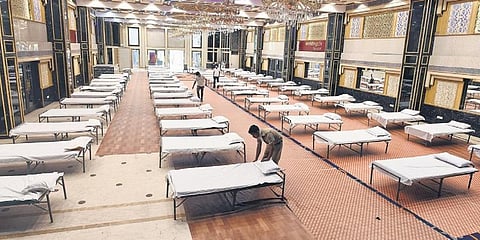 Rows of beds lined up in a hall at the Weddingz.in banquet hall in Kirti Nagar that has been converted into a temporary quarantine facility for people infected with the coronavirus, in New Delhi on Monday. (Photo | Parveen Negi, EPS)