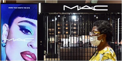 A person wearing a face mask walks past a closed make-up booth on June 22, 2020 in the Brooklyn Borough of New York City. (Photo | AFP)