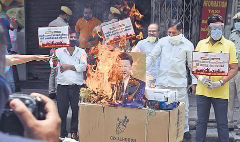 Members of Confederation of All India Traders (CAIT) burn Chinese goods during a protest in New Delhi | Parveen Negi