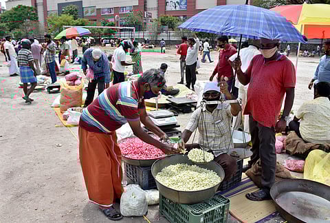 Traders of Flowermarket in Mettupalayam road set up their makeshift shops at Devanga Higher secondry School in Coimbatore on Wednesday. (Photo | U Rakesh Kumar/EPS)