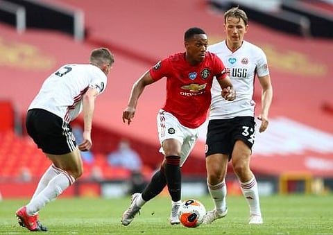 Manchester United's French striker Anthony Martial (C) vies with Sheffield United's Norwegian midfielder Sander Berge (R) during the English Premier League football match. (Photo | AFP)