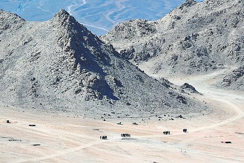 Indian soldiers walk at the foothills of a mountain range near Leh. India is scaling up its military presence in the area following the Galwan Valley clash | AFP