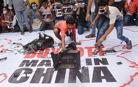 Youth Congress activists smash Chinese products on a banner that reads 'Boycott Made In China' during a protest over the killing of 20 Indian Army soldiers in Ladakh's Galwan Valley by the Chinese People's Liberation Army PLA troops in Kolkata. (Photo | P