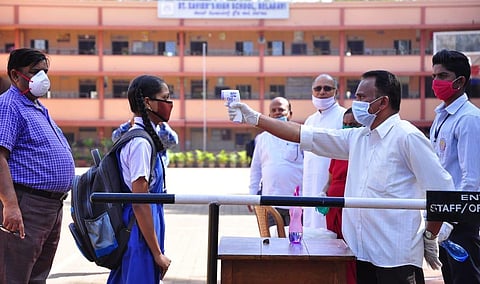 Students undergo thermal screening at an exam centre in Belgavi. (Photo | Ashishkrishna HP, EPS)