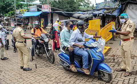 Police constables stop commuters at Appa Pada area in Malad during the fifth phase of COVID-19 lockdown in Mumbai Friday June 26 2020. (Photo | PTI)