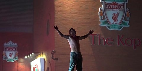 Liverpool fans ignored social distancing rules to gather outside Anfield in celebration of their team's first English title in 30 years on Thursday. (Photo | AP)