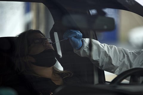 A healthcare worker administers a Covid-19 test at United Memorial Medical Center testing site in Houston, Texas, June 25, 2020. (Photo | AFP)