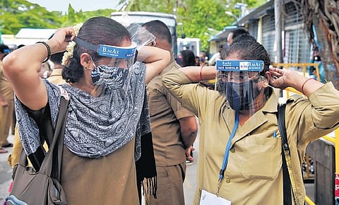 Two women BMTC bus conductors wear face shields distributed by  Mrs India Karnataka team in Bengaluru on Friday | meghana Sastry