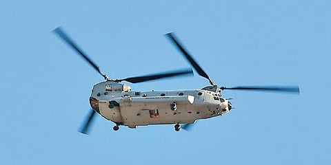An IAF Chinook helicopter flies over a mountain range near Leh on Friday. (Photo | AFP)