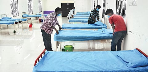 Staff setting up beds at the Covid Care Centre at Anna University on Friday; (inset) a view of the centre | Ashwin prasath