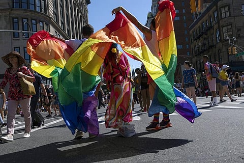 In this June 30, 2019, file photo, parade-goers pose for photographs with rainbow flags during the LBGTQ Pride march in New York. (Photo | AP)