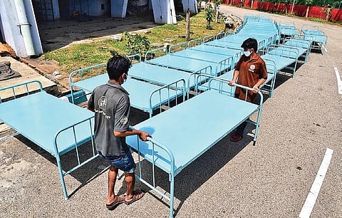 Beds being set up at Bengaluru’s Kanteerva Indoor Stadium on Saturday morning. However, the beds were removed by evening the same day | Shriram BN