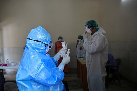 Medical workers wearing personal protective equipment PPE at a testing center during the Government conduct rapid antigen COVID-19 tests at Lado sarai in New Delhi. (Photo | Shekhar Yadav, EPS)