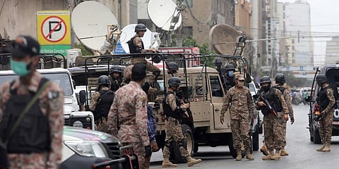 Security personnel surround the Stock Exchange Building after gunmen's attack in Karachi, Pakistan. (Photo | AP)