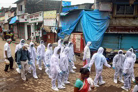 Health workers wearing protective gear arrive for a free medical check-up to analyse the spread of COVID-19 at Appa Pada slum area in Mumbai. (Photo | PTI)