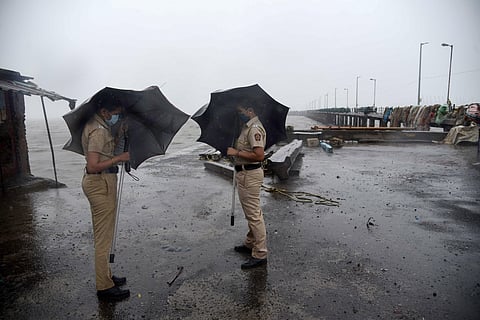 Mumbai Policewoman stand guard at Mora Jetty during Cyclone Nisarga in Navi Mumbai. (Photo | PTI)