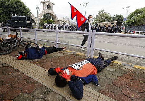 Protesters lie on the ground demanding better handling of the COVID-19 pandemic in Kathmandu, Nepal, Saturday, June 20, 2020. (Photo | AP)