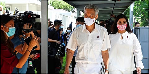 People's Action Party Secretary-General and Singaporean Prime Minister Lee Hsien Loong, center, arrives at a nomination center with his team to submit their nomination papers ahead of the general election in Singapore, Tuesday, June 30, 2020. (Photo | AP)