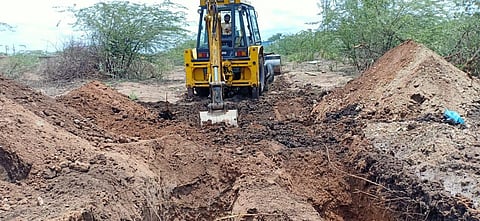 An earthmover at the burial site on Ballari outskirts where eight bodies were cremated on Monday. (Photo | Express)