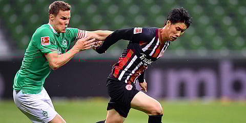 Frankfurt's Daichi Kamada and Bremen's Niklas Moisander challenges for the ball during the German Bundesliga soccer match between SV Werder Bremen and Eintracht Frankfurt in Bremen, Germany. (Photo| AP)