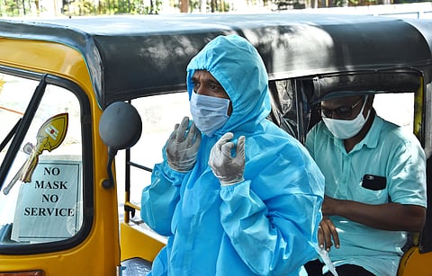 Dilip Kumar auto driver from velachery wearing PPE suit and driving his auto for customers safety and creating an awareness among other auto drivers in the city.  (Photo | Ashwin Prasath/EPS)