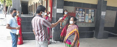 Staff of a private school undergo thermal screening in Hyderabad  on Thursday as schools are getting ready to conduct the remaining Class 10 examinations |RVK Rao