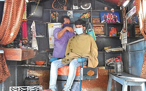 A man gets haircut at a salon in a Renigunta village on Thursday. (Photo | Madhav K, EPS)