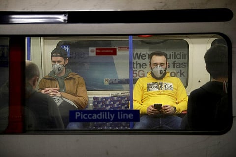 Passengers wearing face masks travel on a Piccadilly Line underground train in London. (Photo | AP)