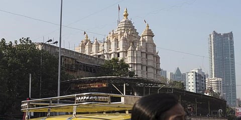 Commuters get out of a taxi in front of Shree Siddhivinayak Ganapati Temple in Mumbai. (File photo| Reuters)