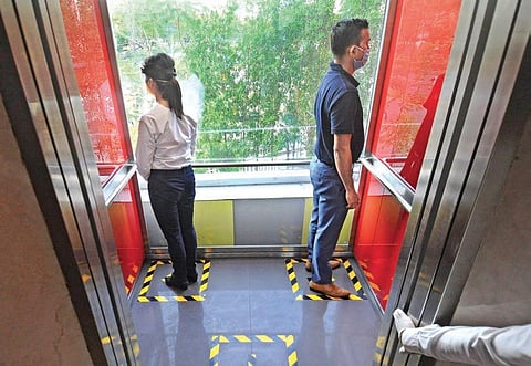 Arrangements to maintain physical distancing in an elevator of a restaurant in Vijayawada on Saturday I Prasant Madugula