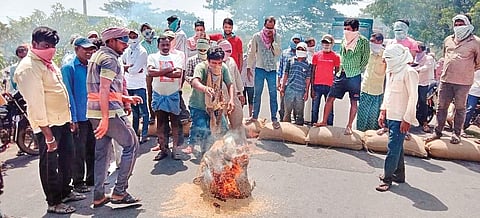 Farmers burn a few bags of their produce demanding the State government to make all necessary arrangements for procuring their crop without further delay, at Malharrao mandal in Jayashankar Bhupalpally district on Sunday