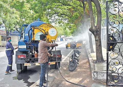 As Covid-19 cases shoot up in the city, HMWSSB workers spray disinfectant on roads near Koti on Sunday | S Senbagapandiyan