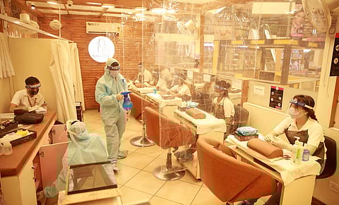 Beauticians wearing protective gear inside a parlour at a shopping mall in New Delhi. (Photo | Shekhar Yadav, EPS)