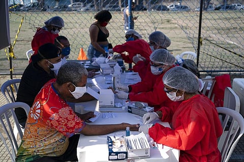 A health worker takes a blood sample from a man to test for COVID-19 amid the new coronavirus pandemic at a plaza in Duque de Caxias, Brazil, Monday, June 8, 2020. (Photo | AP)